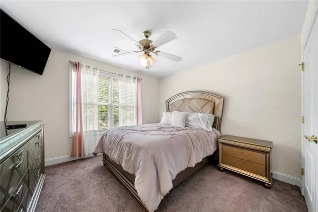 a bed room with a bed and a television