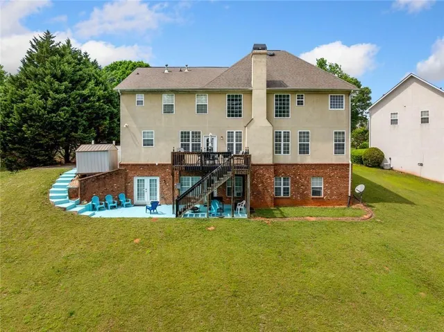 a view of a house with pool and sitting area