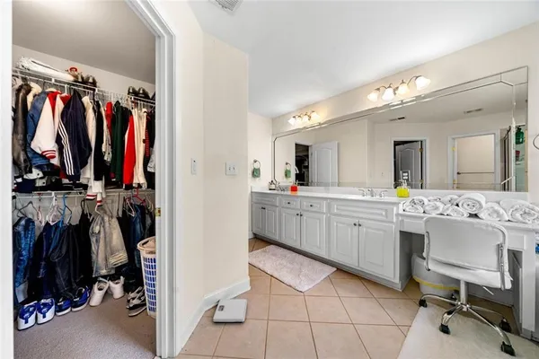 a view of a walk in closet with clothes