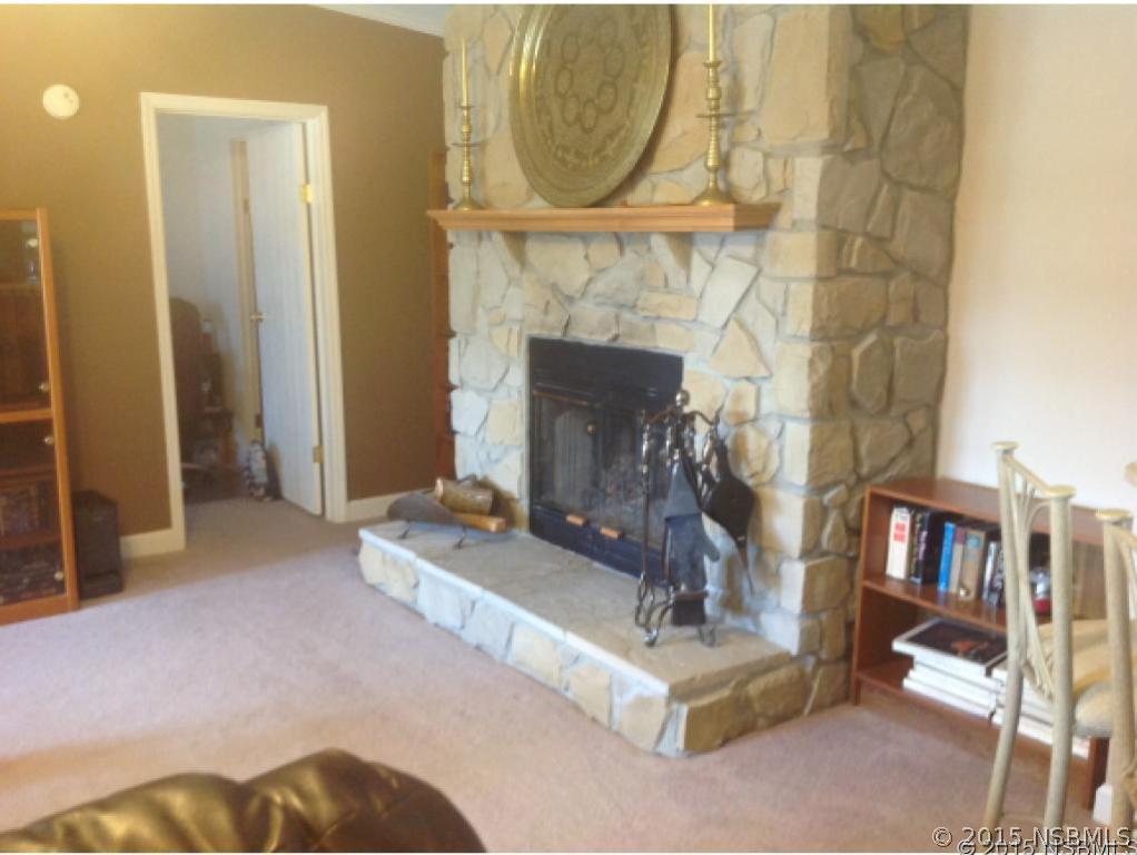 742 Navigators Way Edgewater, FL 32141 - Photo 5 of 15 a living room with furniture and a fireplace
