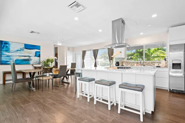 a kitchen with counter space dining table and chairs