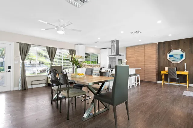 a dining room with furniture and wooden floor