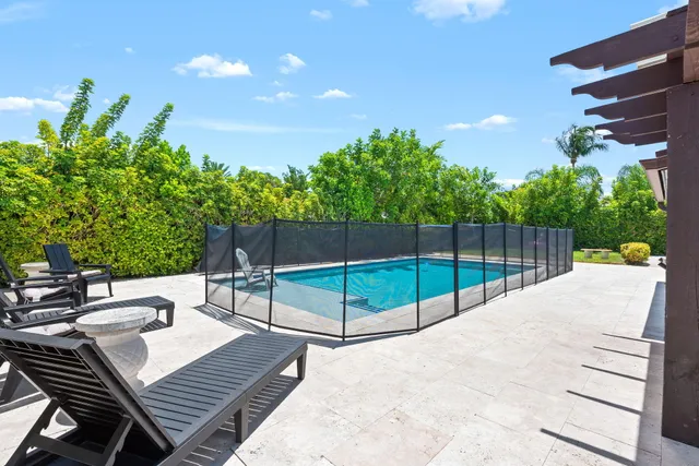 a view of a backyard with sitting area