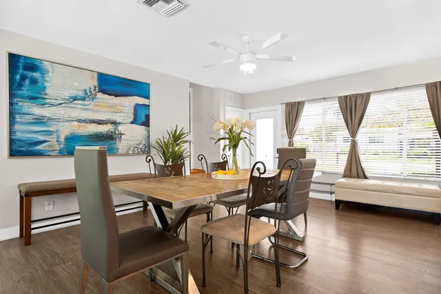 a view of a dining room with furniture window and wooden floor