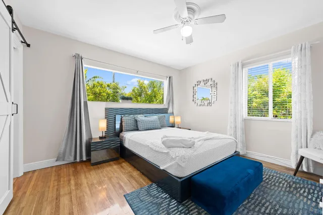 a bedroom with a bed and a window