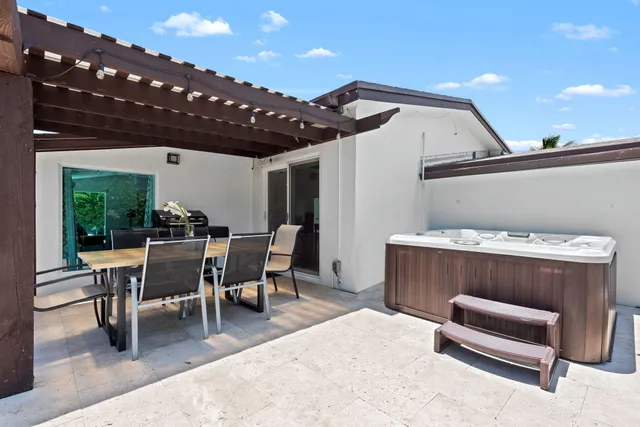 a view of a patio with table and chairs with wooden floor