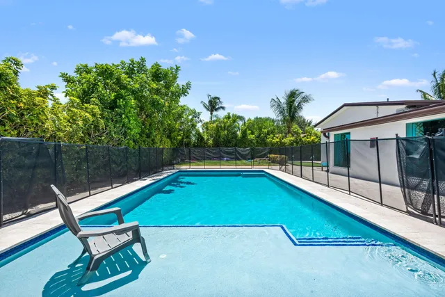 a small pool with a bench in front of it