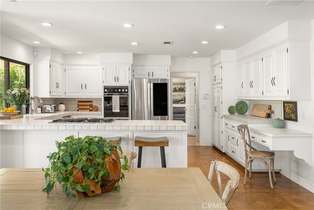 9741 Rangeview Drive North Tustin, CA 92705 - Photo 13 of 48 a living room with stainless steel appliances kitchen island granite countertop a stove and a refrigerator