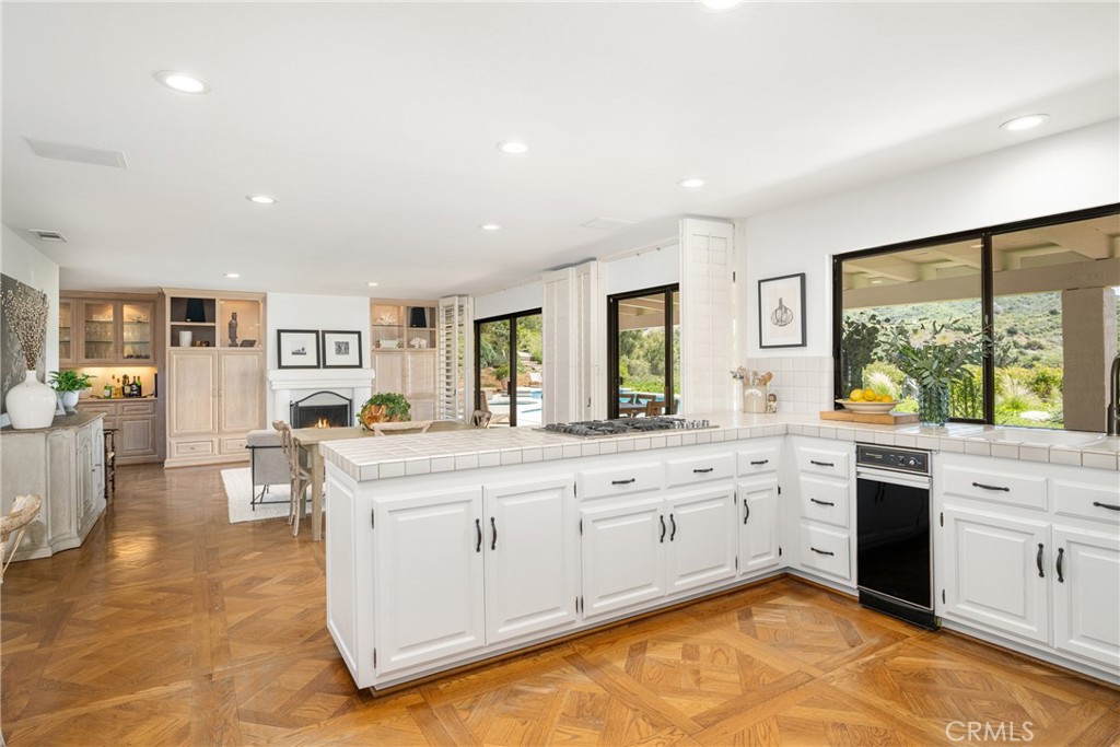 9741 Rangeview Drive North Tustin, CA 92705 - Photo 14 of 48 a large white kitchen with a large window