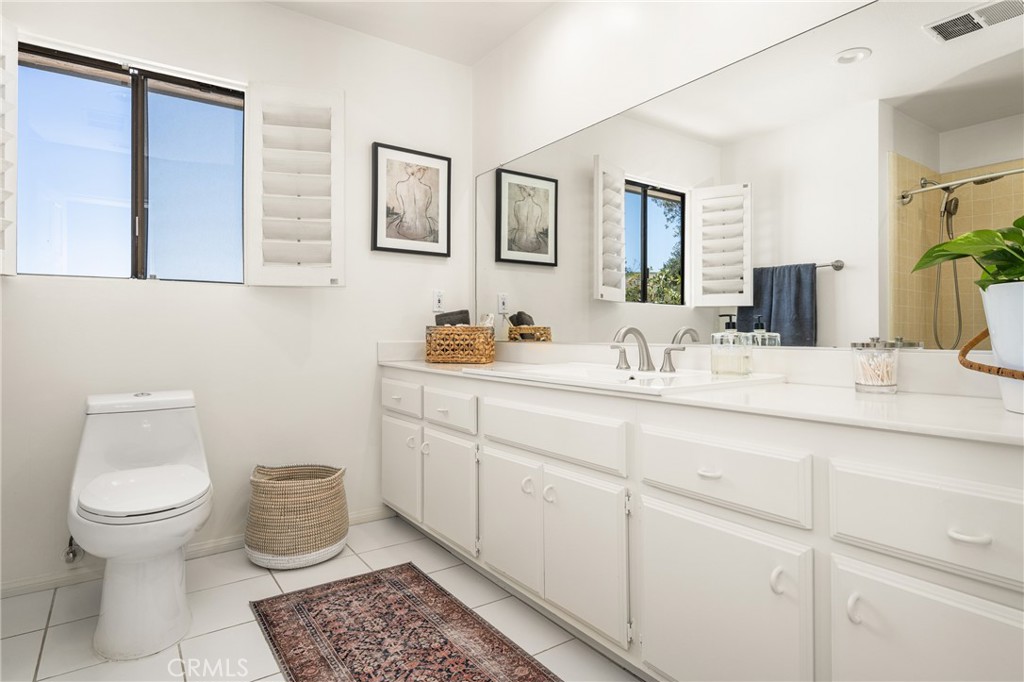 9741 Rangeview Drive North Tustin, CA 92705 - Photo 29 of 48 a bathroom with a toilet sink and mirror