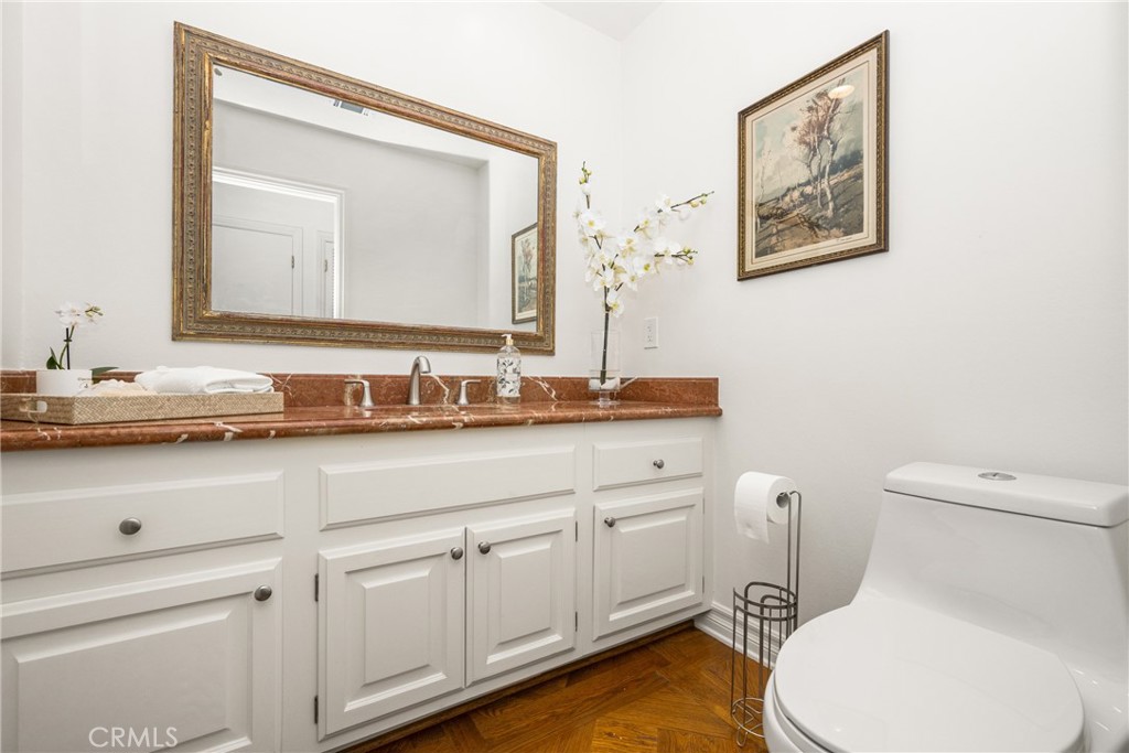 9741 Rangeview Drive North Tustin, CA 92705 - Photo 30 of 48 a bathroom with a toilet a sink and mirror
