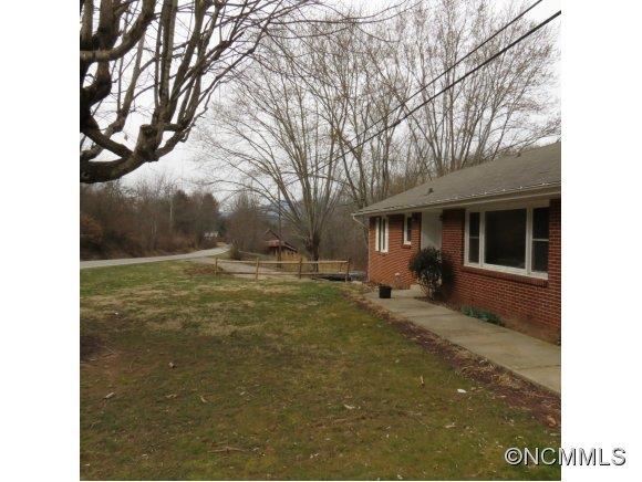 2005 Ratcliff Cove Road Waynesville, NC 28786 - Photo 17 of 20 a view of a house with backyard and trees
