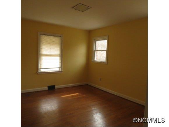 2005 Ratcliff Cove Road Waynesville, NC 28786 - Photo 5 of 20 a view of an empty room with wooden floor and a window