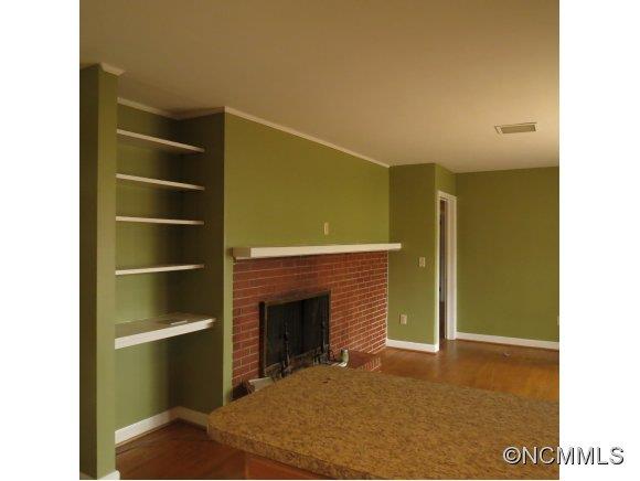 2005 Ratcliff Cove Road Waynesville, NC 28786 - Photo 8 of 20 a view of an empty room with a fireplace