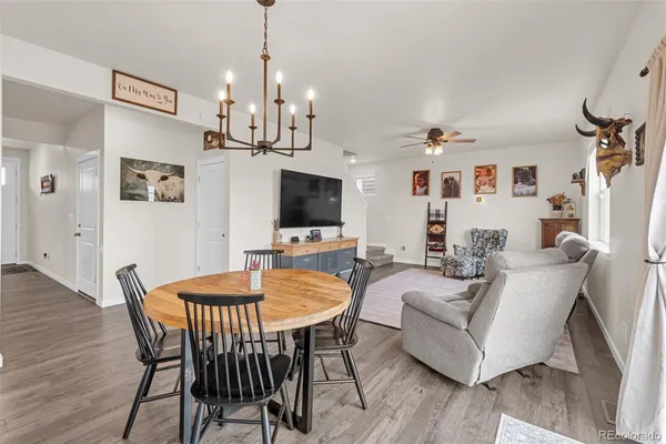 a spacious bedroom with a bed a couch and a chandelier