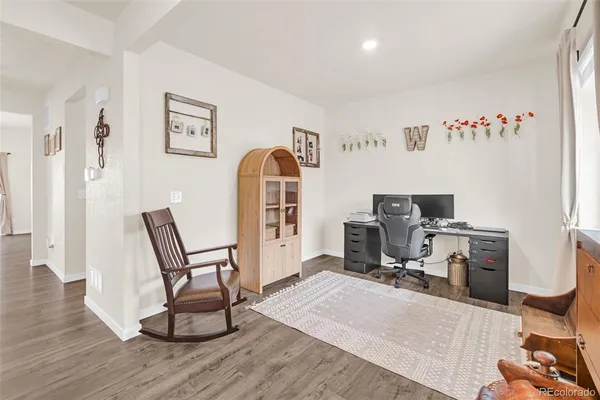 a kitchen with stainless steel appliances granite countertop a sink a stove a refrigerator cabinets and dining table