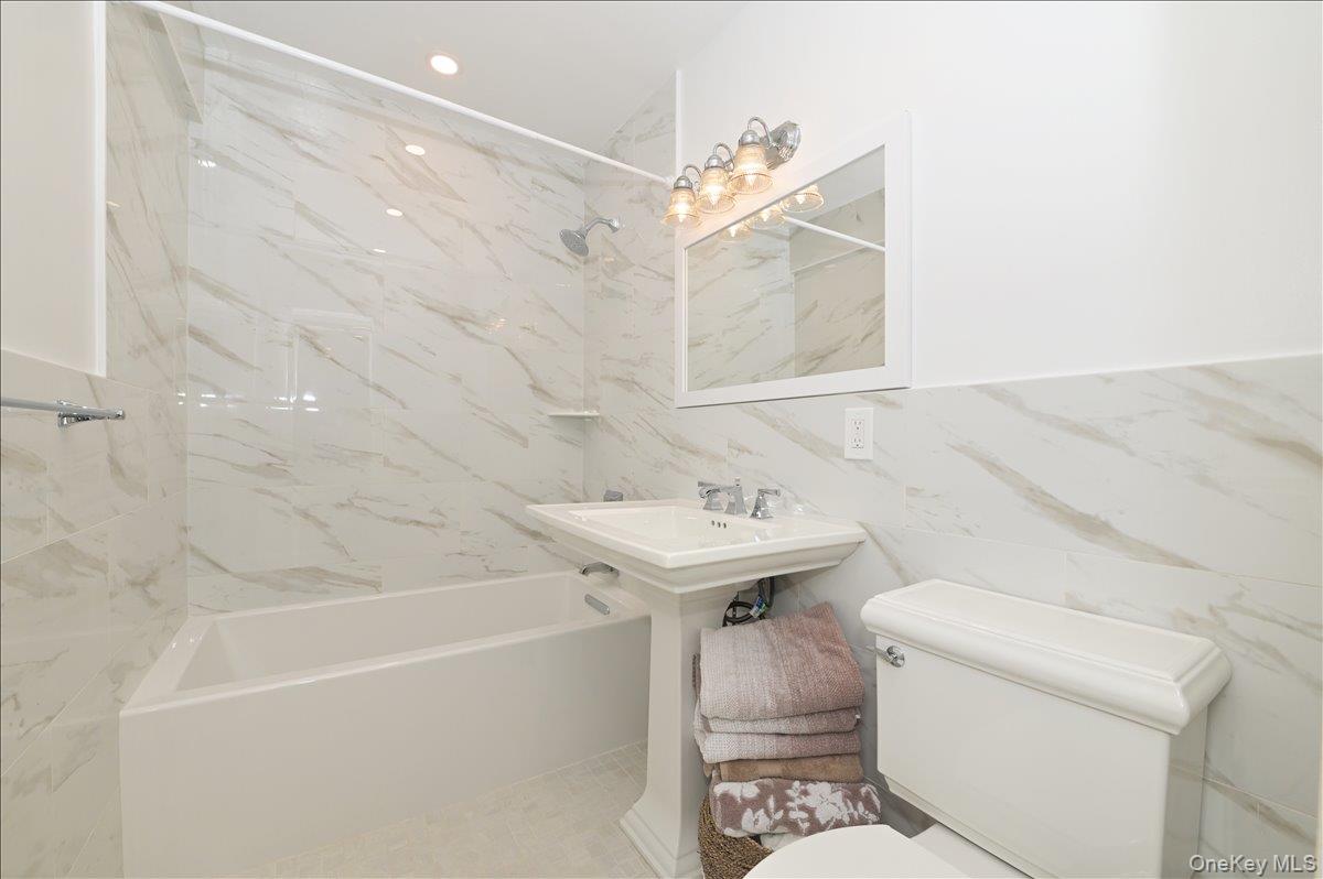 320 East Shore Road, Unit 4C Great Neck, NY 11023 - Photo 18 of 29 Full bath with shower / washtub combination and tile walls