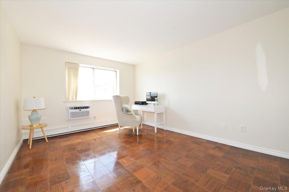 320 East Shore Road, Unit 4C Great Neck, NY 11023 - Photo 21 of 31 Home office with a baseboard heating unit, parquet floors, and a wall mounted AC