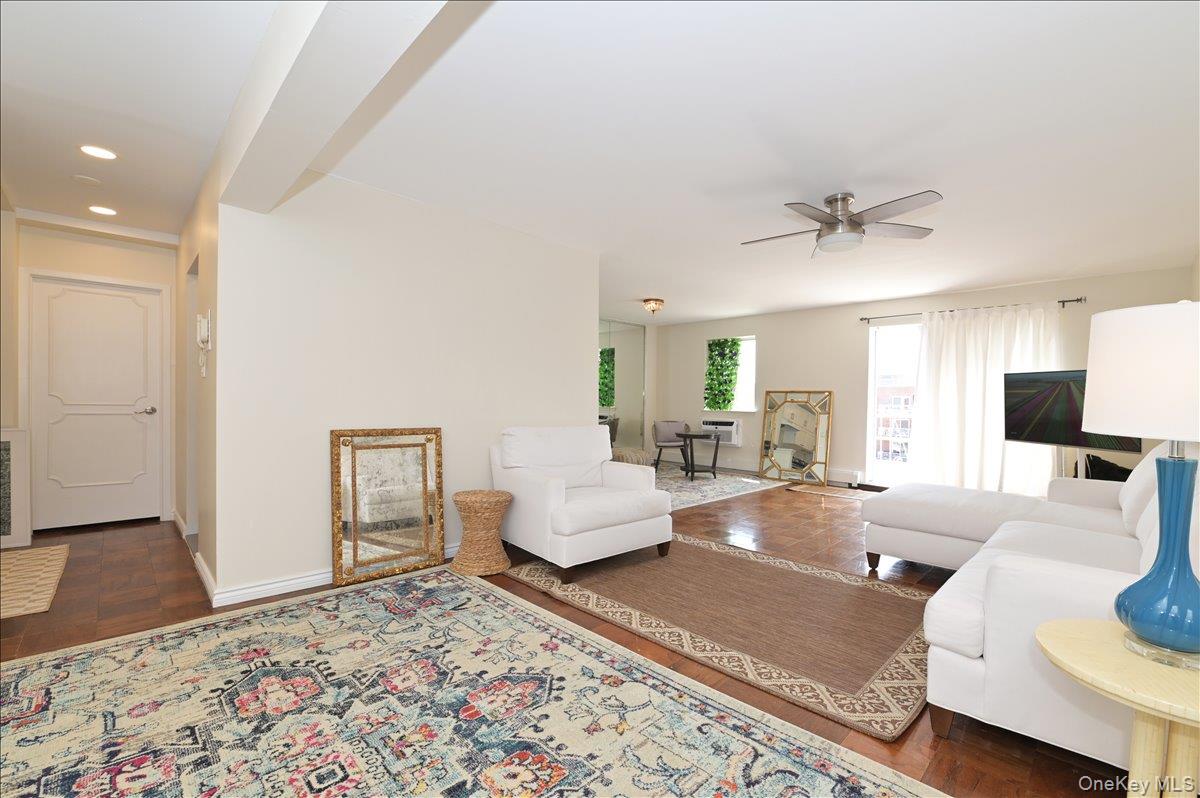 320 East Shore Road, Unit 4C Great Neck, NY 11023 - Photo 8 of 31 Living area featuring dark wood-style flooring and ceiling fan