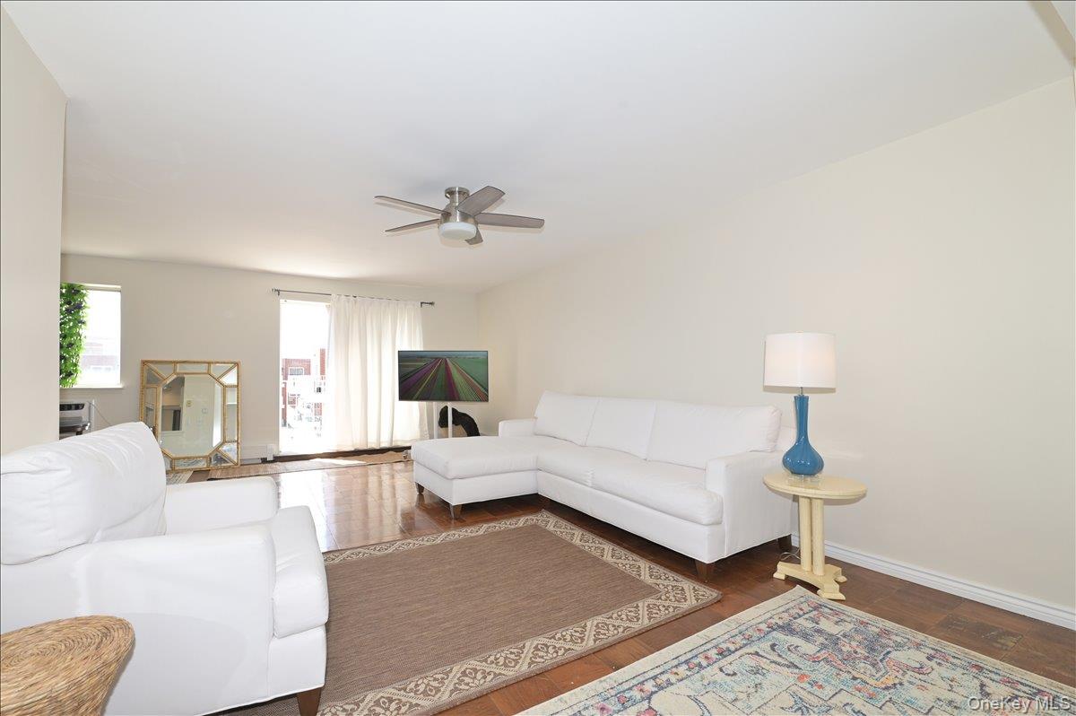 320 East Shore Road, Unit 4C Great Neck, NY 11023 - Photo 9 of 31 Living room with a ceiling fan and wood finished floors