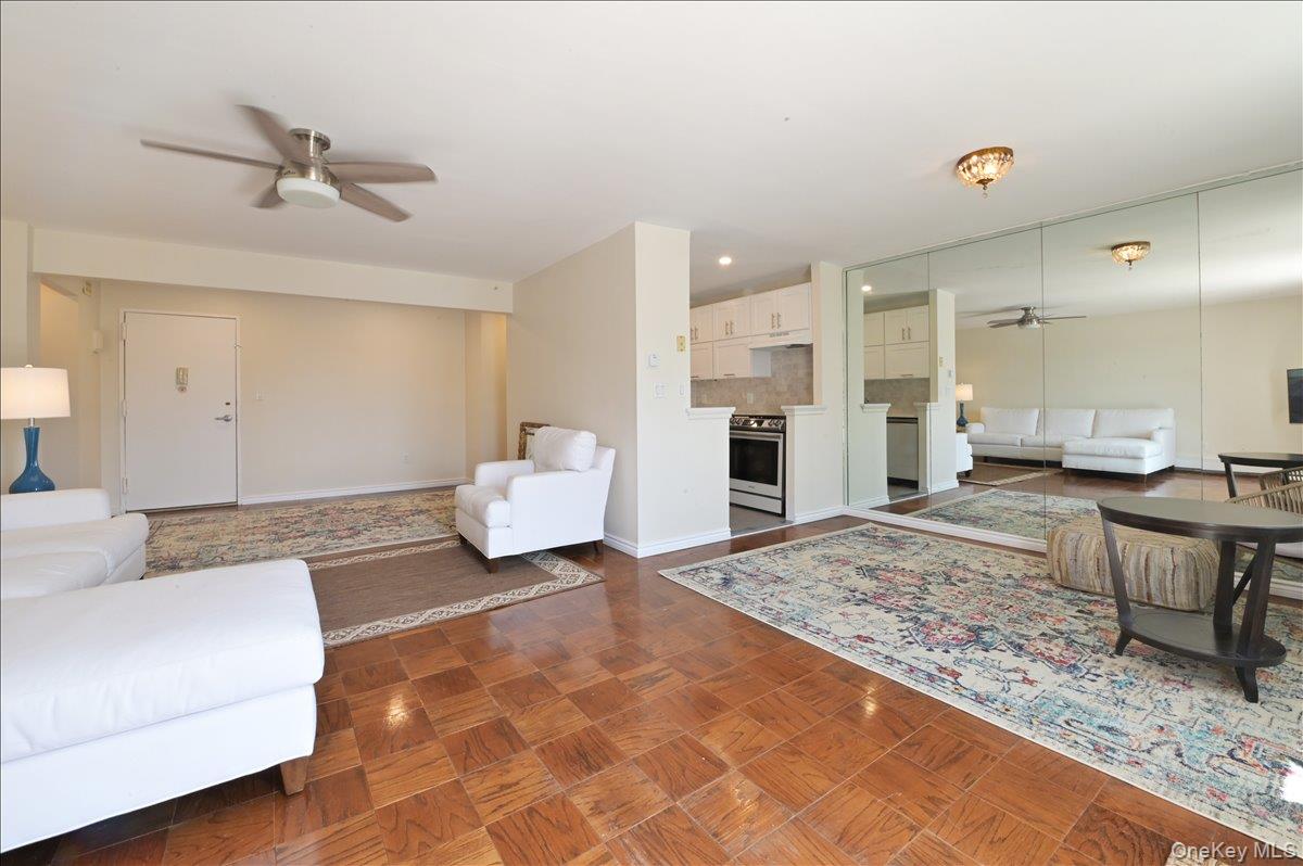 320 East Shore Road, Unit 4C Great Neck, NY 11023 - Photo 10 of 31 Living room with ceiling fan and parquet flooring