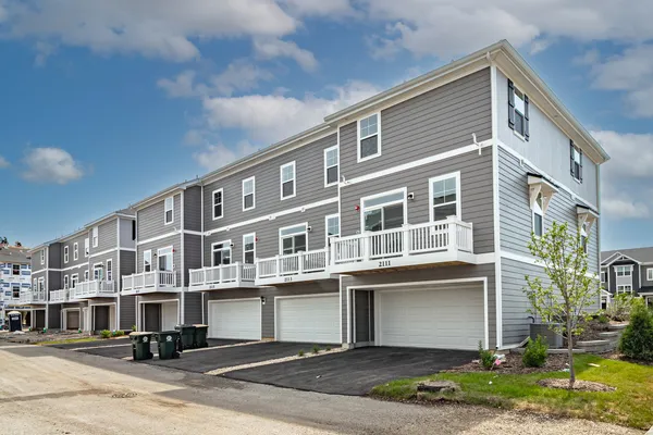 a front view of a building with a garden