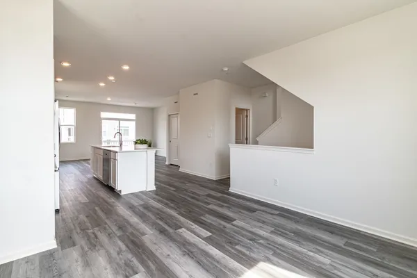 a view of kitchen and hall with wooden floor