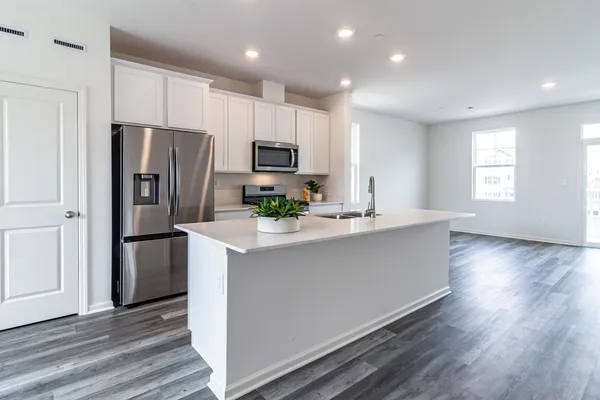 a kitchen with stainless steel appliances a refrigerator stove microwave and cabinets