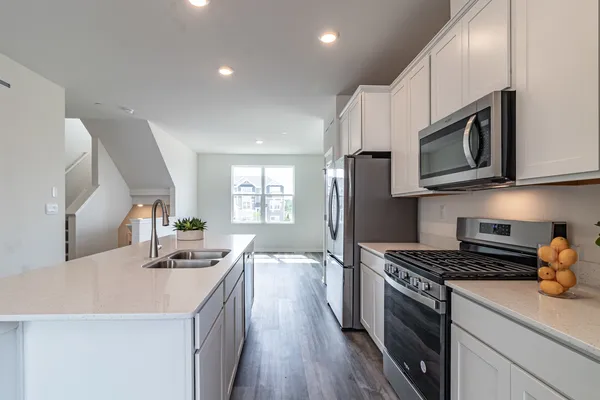 a kitchen with stainless steel appliances a sink microwave and stove