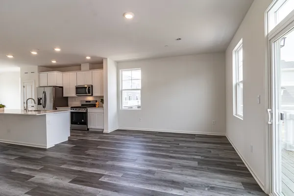 a view of kitchen with wooden floor and electronic appliances