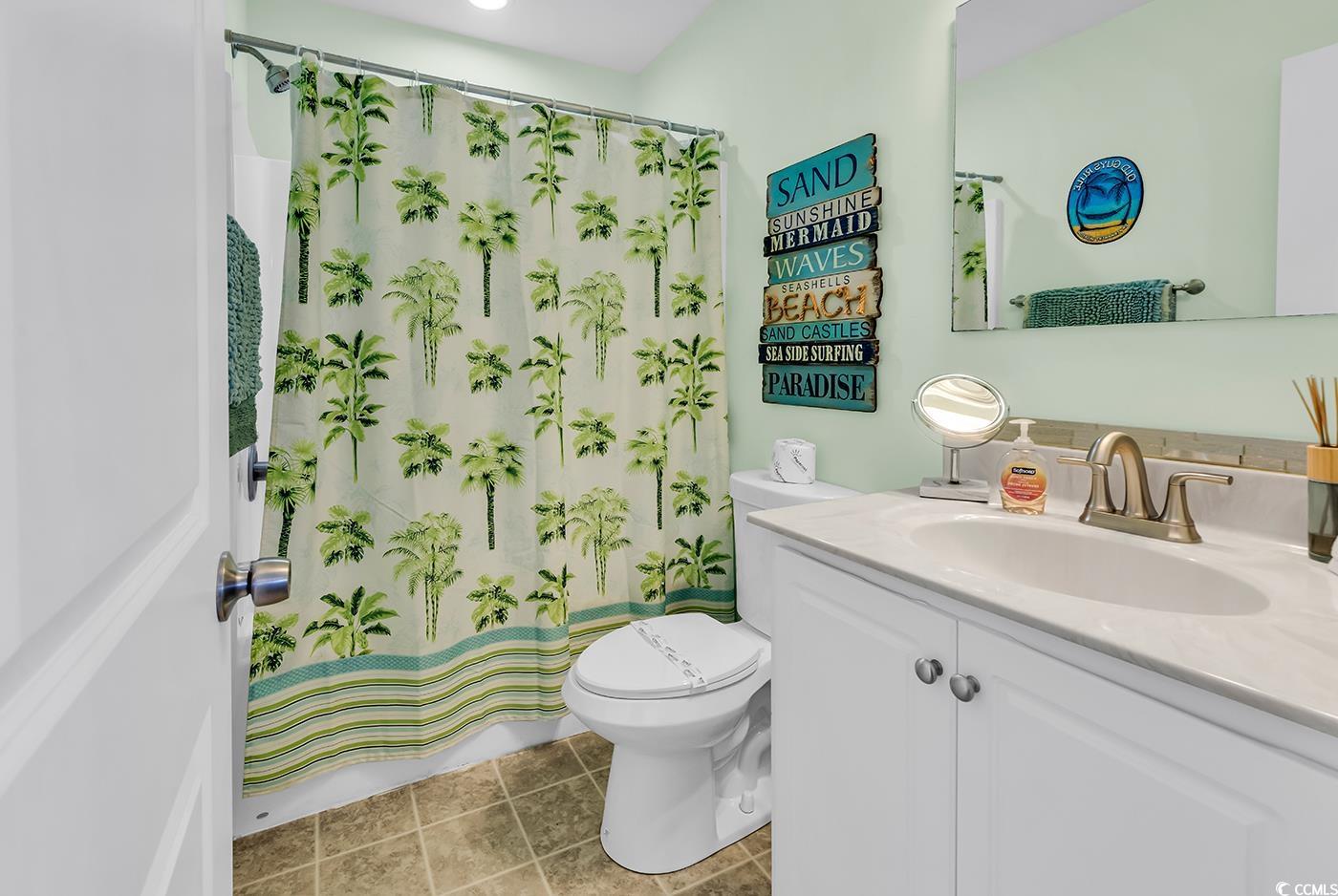 124 B Vista Drive Murrells Inlet, SC 29576 - Photo 27 of 38 Full bathroom with a shower with shower curtain, vanity, and light tile patterned flooring