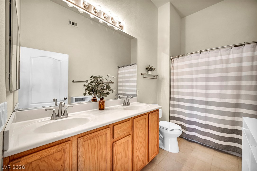 2305 West Horizon Ridge Parkway, Unit 3621 Henderson, NV 89052 - Photo 13 of 23 Double vanity sinks and bright lighting illuminate this spacious, well-appointed bathroom.