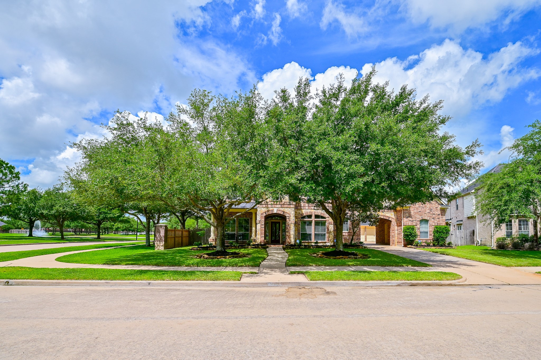 7218 Spring Run Lane Katy, TX 77494 - Photo 4 of 49 a front view of a house with a yard and large trees