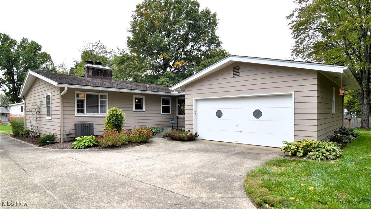 2071 Wyndham Road Akron, OH 44313 - Photo 39 of 42 Single story home featuring a garage, concrete driveway and side entrance.