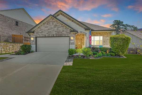 a front view of a house with garden