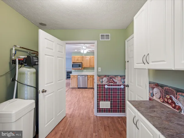 a kitchen with a refrigerator and a stove top oven