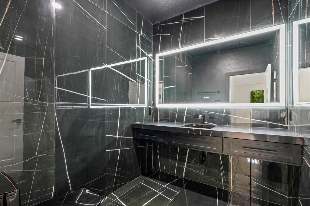 1312 Compton Street Dallas, TX 75203 - Photo 13 of 31 a bathroom with a sink and a mirror