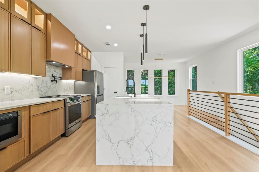 1312 Compton Street Dallas, TX 75203 - Photo 14 of 31 a large kitchen with kitchen island granite countertop a large window