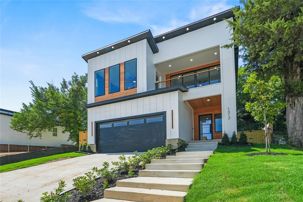 1312 Compton Street Dallas, TX 75203 - Photo 2 of 31 a front view of a house with a yard and garage