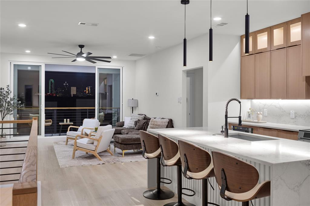 1312 Compton Street Dallas, TX 75203 - Photo 26 of 31 a kitchen with stainless steel appliances granite countertop a sink a stove and a dining table with wooden floor
