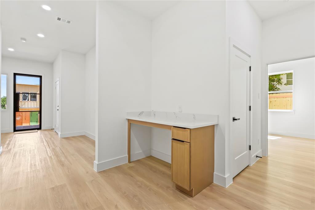 1312 Compton Street Dallas, TX 75203 - Photo 8 of 31 a view of an empty room with wooden floor and a window