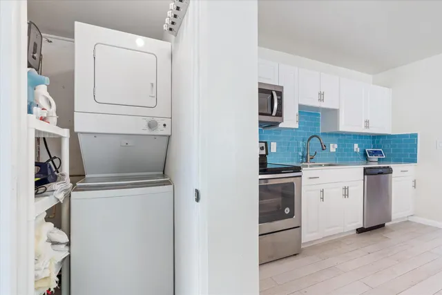 a kitchen with stainless steel appliances a stove microwave and sink