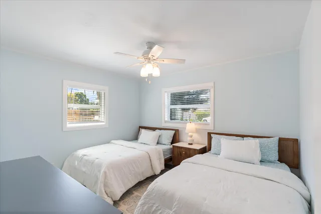 a bedroom with two beds and a chandelier