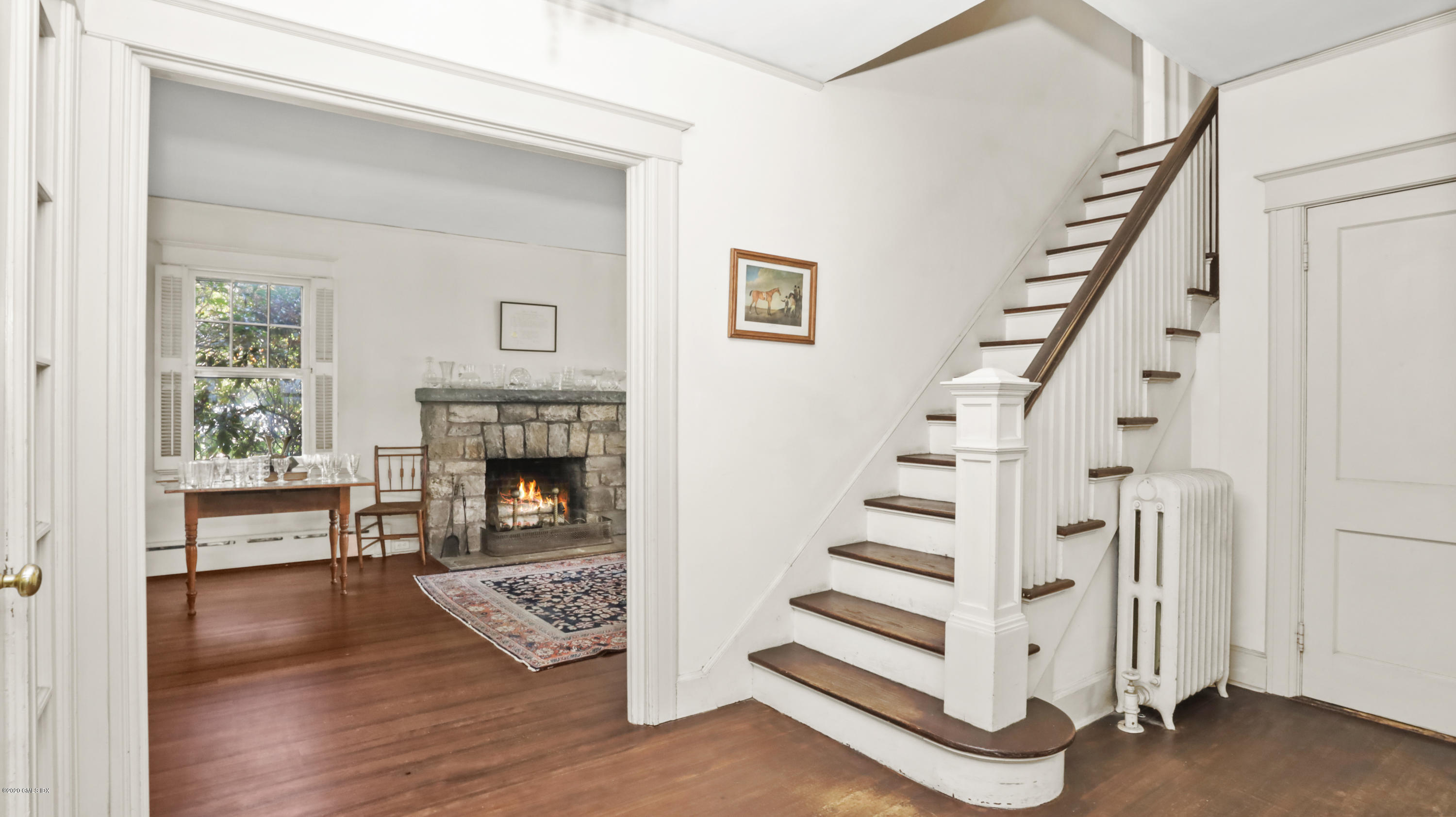30 Hendrie Avenue Riverside, CT 06878 - Photo 3 of 31 a view of a livingroom with wooden floor and a fireplace