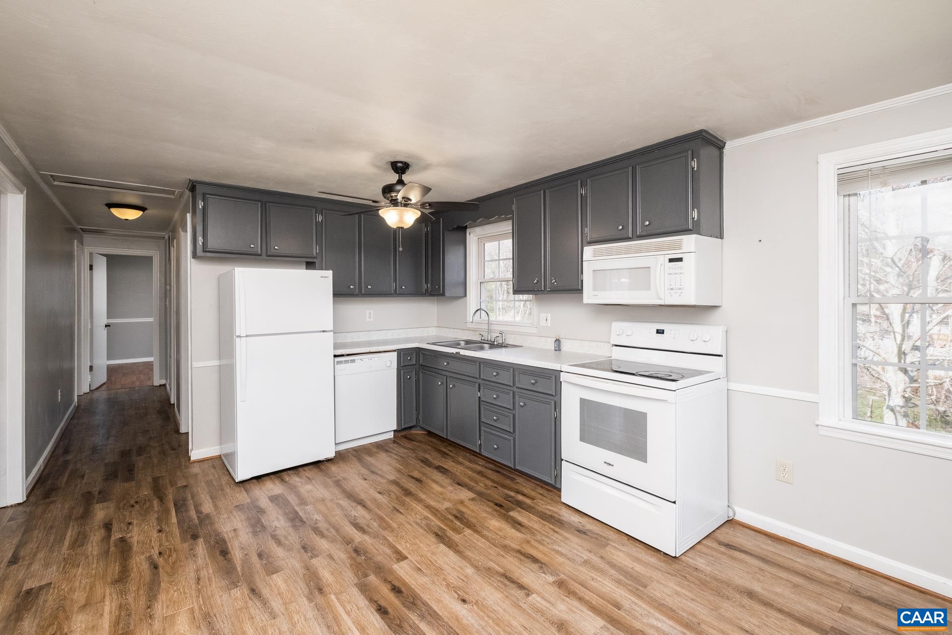 397 Carpenters Mill Road Ruckersville, VA 22968 - Photo 6 of 30 a kitchen with white cabinets and white appliances