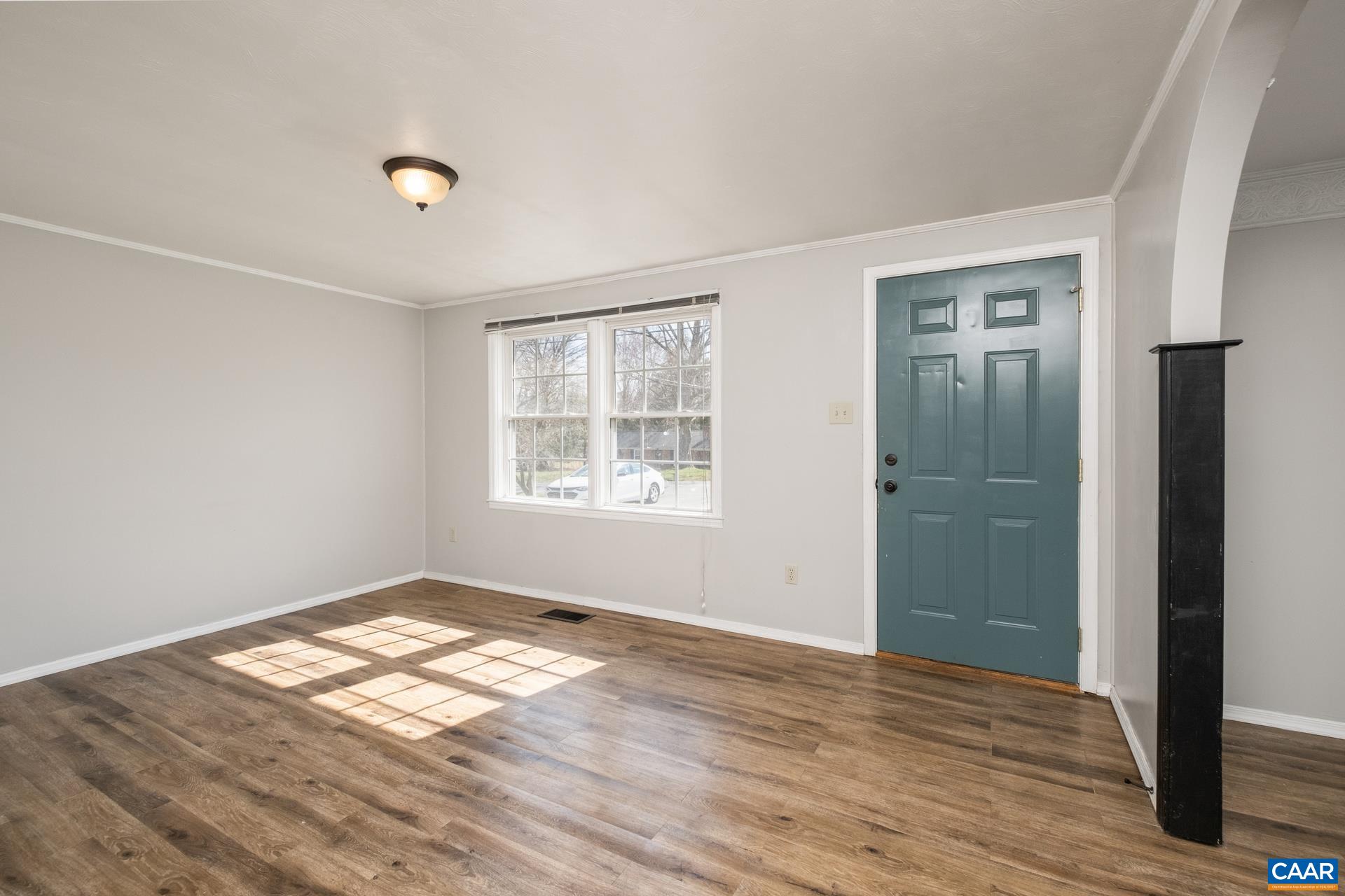 397 Carpenters Mill Road Ruckersville, VA 22968 - Photo 8 of 30 an empty room with wooden floor and windows