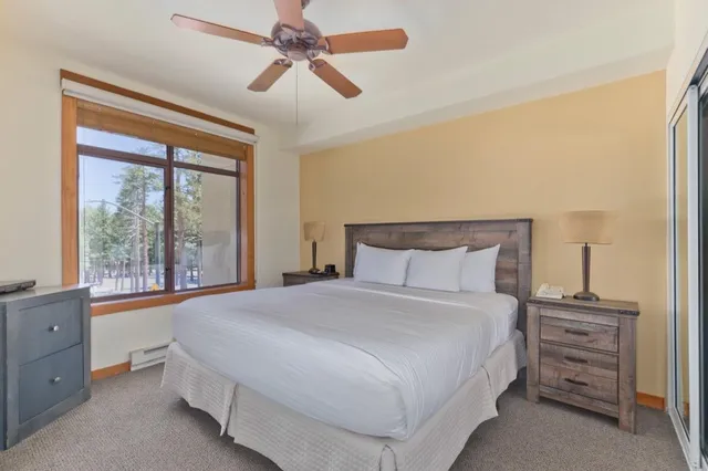 a bedroom with a large bed and a window