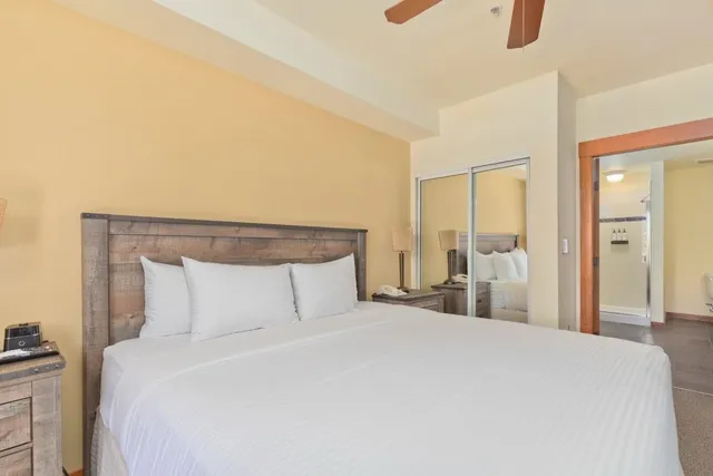 a bedroom with a bed and a night stand