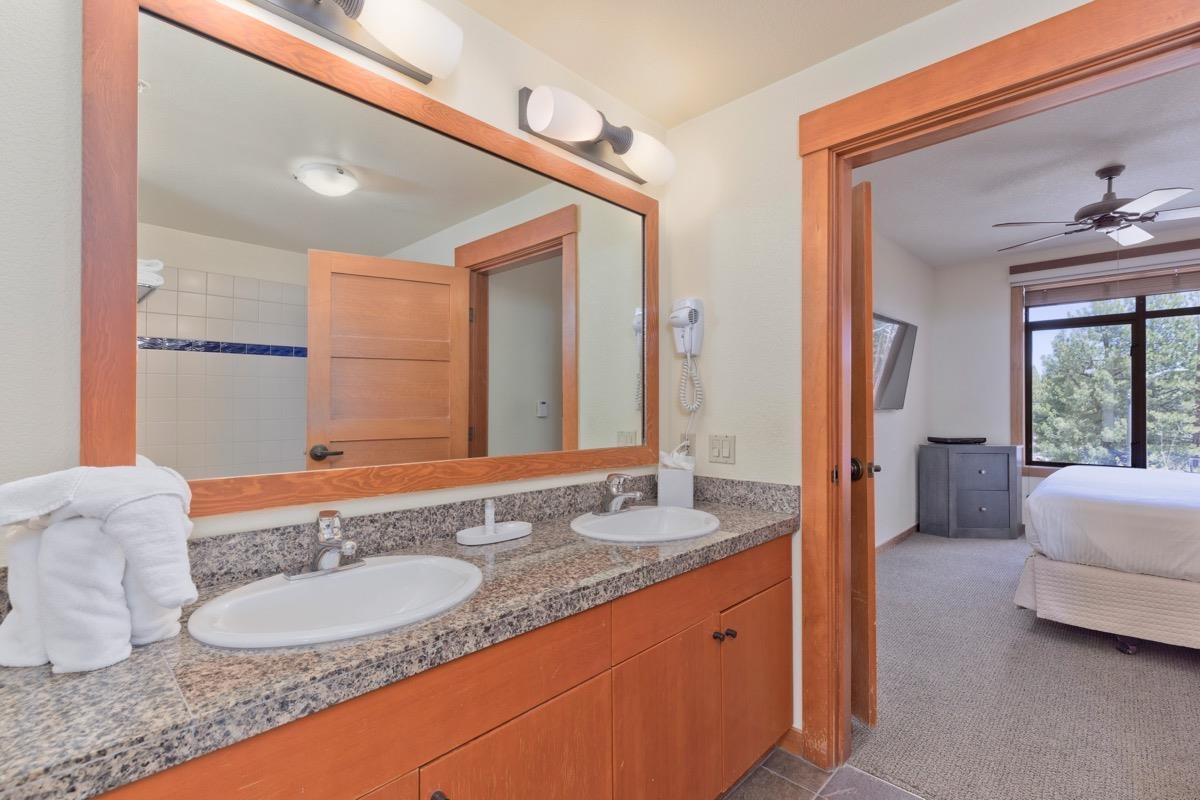6201 Minaret Road, Unit 2215 Mammoth Lakes, CA 93546 - Photo 21 of 33 a spacious bathroom with a granite countertop sink and a mirror
