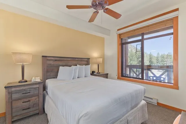 a bedroom with a large bed and a window